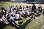 Coach Barry Campbell speaks with the Kingwood High School football team at the end of practice Thursday