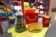 A Happy Meal featuring non-fat chocolate milk and a cheeseburger with fries