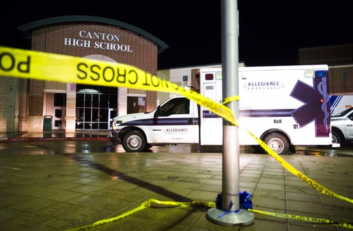 Ambulances and emergency vehicles line up at Canton High School after a tornado ripped through the city of Canton