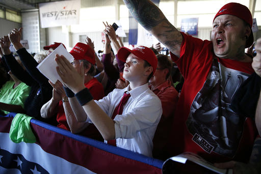 Supporters of Republican presidential candidate Donald Trump cheer as they listen to Trump speak at a campaign rally