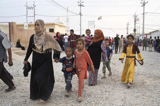 People arrive at a camp for displaced families in Dibaga