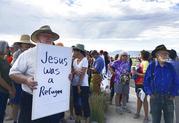 Demonstrators rally in support of Iraqi refugee Kadhim Al-bumohammed outside of Immigration and Customs Enforcement offices in Albuquerque on Thursday