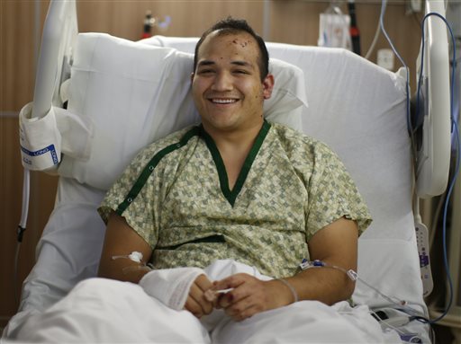 Lt. Peter St. John of Portland Fire & Rescue lies in a bed