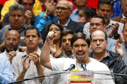 National Assembly first Vice President Freddy Guevara speaks to the press accompanied by fellow lawmakers in Caracas