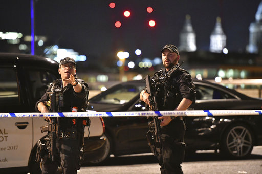 Armed Police officers stand guard on London Bridge in central London