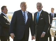 President Donald Trump stands on the tarmac with South Carolina Gov. Henry McMaster as he arrives on Air Force One at Greenville Spartanburg International Airport