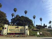 A helicopter prepares to make a water drop over the San Luis Rey Training Center