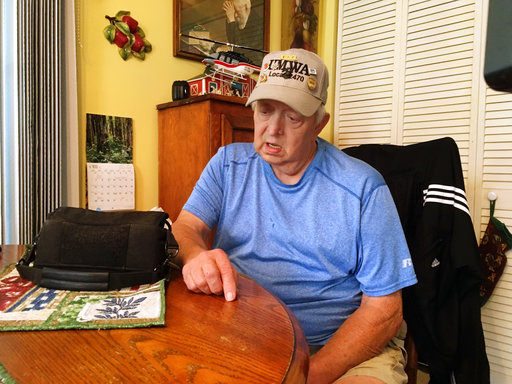 Retired coal miner Kenny Smith sits at his kitchen table in Centertown