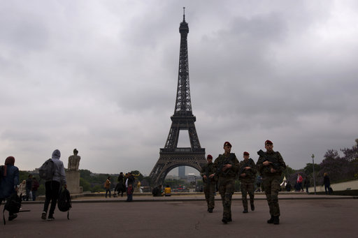 Army soldiers patrol near Trocadero plaza with the Eiffel Tower in the background in Paris