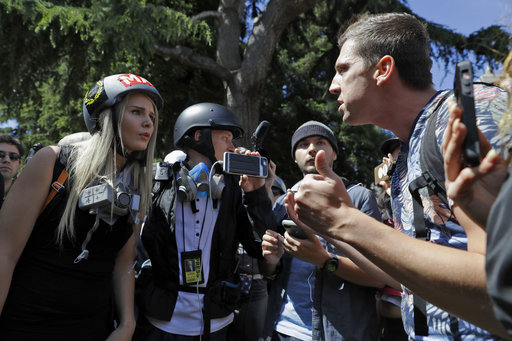 Demonstrators sharing opposing views argue during a rally Thursday