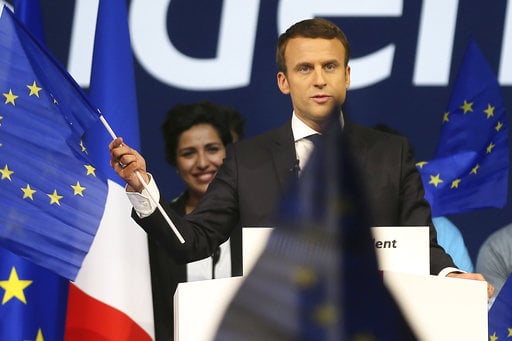 Independent centrist candidate Emmanuel Macron waves an European flag during a meeting in Nantes