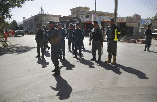 Policemen stand guard at the site of a suicide attack in Kabul