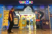 A man walks in front of the Toys R Us store at a shopping mall in Subang Jaya