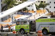 Emergency personnel responds to a collapsed pedestrian bridge connecting Florida International University Florida International on Thursday