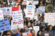 Demonstrators cheer during a "March for Our Lives" protest for gun legislation and school safety Saturday