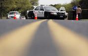 An Austin police officer talks with a woman at a barrier near the site of Sunday's explosion