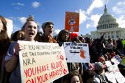 Students hold up their signs during a rally asking for gun control outside of the U.S. Capitol building