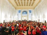 Teachers celebrate after West Virginia Gov. Jim Justice and Senate Republicans announced they reached a tentative deal to end a statewide teachers' strike by giving them 5 percent raises in Charleston