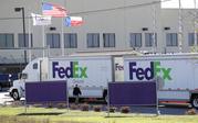 An FBI agent investigates at a FedEx distribution center where a package exploded