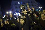 Women bang pots and pans as shooting slogans during a protest marking the beginning of a 24-hour women strike at the Sol square in Madrid