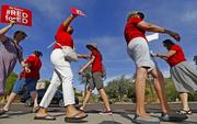 Arizona teachers protest their low pay and school funding in front of a local radio station waiting for Republican Gov. Doug Ducey to show up for a live broadcast Tuesday