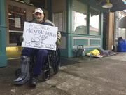 David Abbs holds a sign on Monday