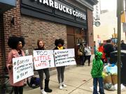 Protesters gather outside a Starbucks in Philadelphia