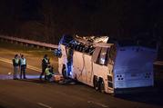 A bus that was carrying teenage passengers sits on the side of a highway after it hit an overpass on the Southern State Parkway in Lakeview