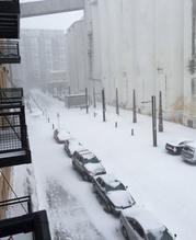Snow blankets cars in an alley in downtown Minneapolis on Saturday
