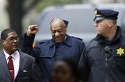 Bill Cosby gestures as he arrives for his sexual assault trial