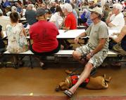 Residents from the lava affected areas of the Big Island hold a prayer before the start of a community meeting with local authorities at Pahoa High School