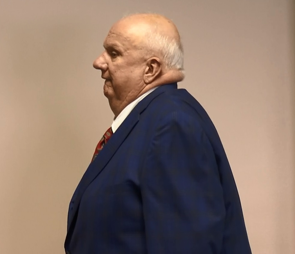 Scott County coroner appears in court  to plead not guilty to charges.