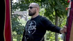 PHOTO: Denis, a member of the Union of Orthodox Banner-Bearers, marches with a banner to commemorate 100 years since the killing of Tsar Nicholas II, in Spaso-Andronikov Monastery in Moscow, July 17, 2018.