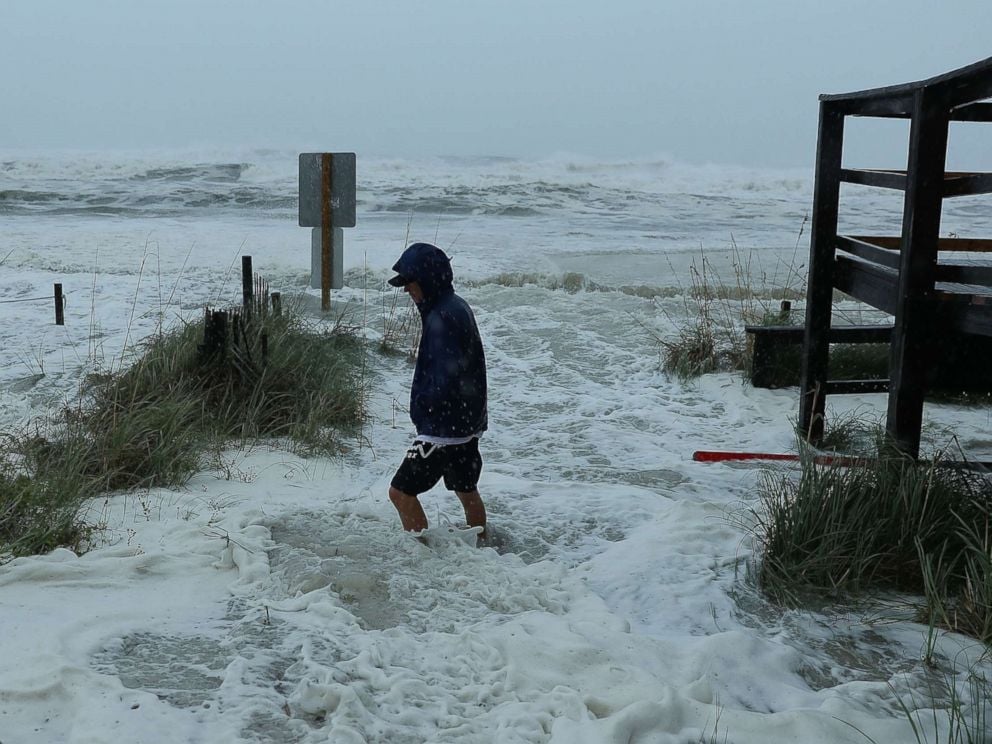 PHOTO: Cameron Sadowski walks along where waves are crashing onto the beach as the outer bands of hurricane Michael arrive, Oct. 10, 2018 in Panama City Beach, Fla.