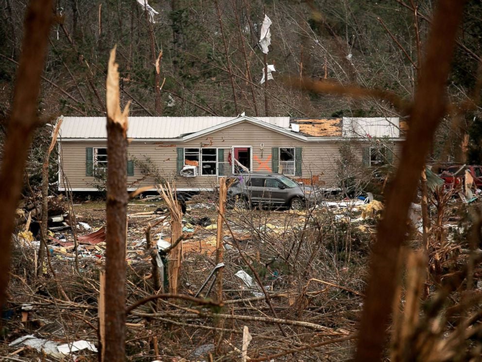 PHOTO: A house with an X painted on it is seen across a hillside of wreckage after two deadly back-to-back tornadoes, in Beauregard, Ala., March 4, 2019.