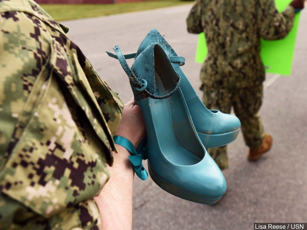 A U.S. service member carries a pair of shoes