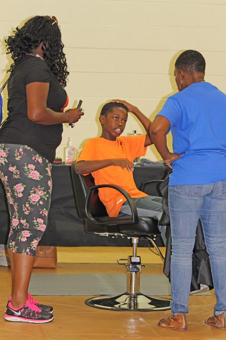 Volunteers say kids can stop by and receive a free haircut from area professionals