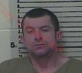 Accused of burglarizing a building on property in Clay County. Held at gunpoint by homeowners.