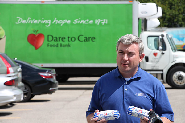 Agriculture Commissioner Dr. Ryan Quarles holds two pounds of Purnell's "Old Folks" at Dare To Care Food Bank in Louisville