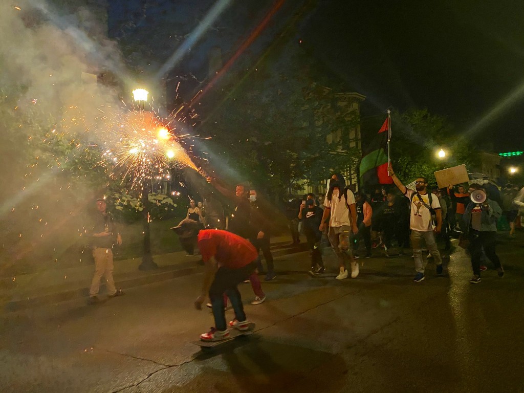 Protesters light fireworks during Sunday