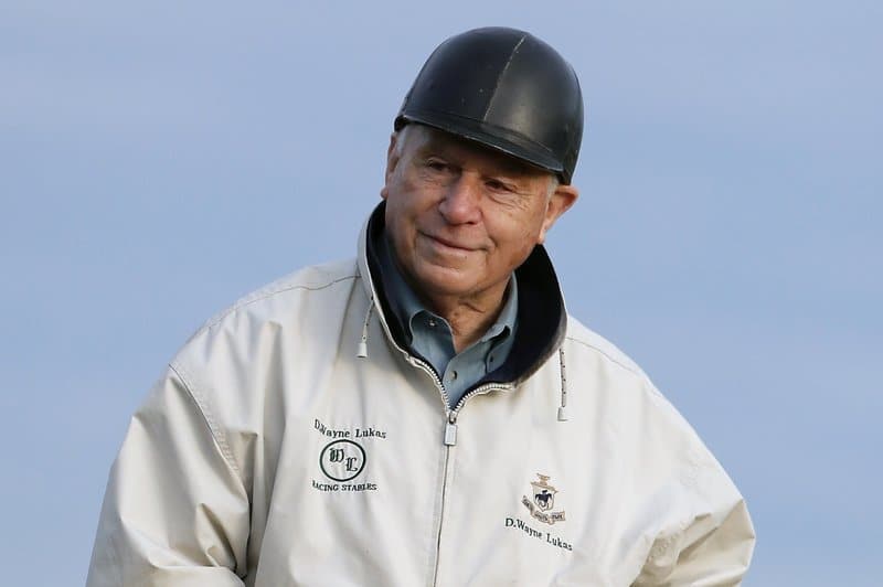 AP FILE - Trainer D. Wayne Lukas rides along the track while watching workouts at Belmont Park