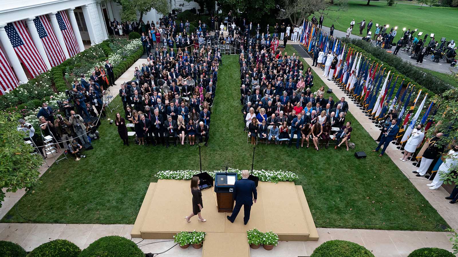Judge Amy Coney Barrett walks to the microphone after President Donald Trump, right, announced Barrett as his nominee to the Supreme Court, in the Rose Garden at the White House, Saturday, September 26 in Washington.