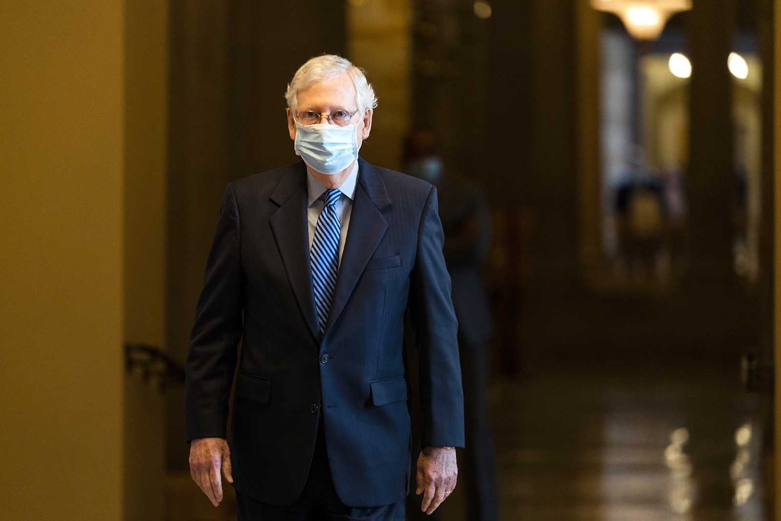 Senate Majority Leader Sen. Mitch McConnell walks towards the Senate floor on Capitol Hill on Thursday, Oct. 1, in Washington.