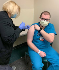 Dalton Henderson, RN, Emergency Department, receives the Moderna vaccine on Saturday at Baptist Health Paducah.