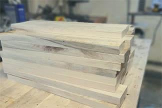 A stack of sweetgum lumber that has been planed and cut. A stack of sweetgum lumber that has been planed and cut