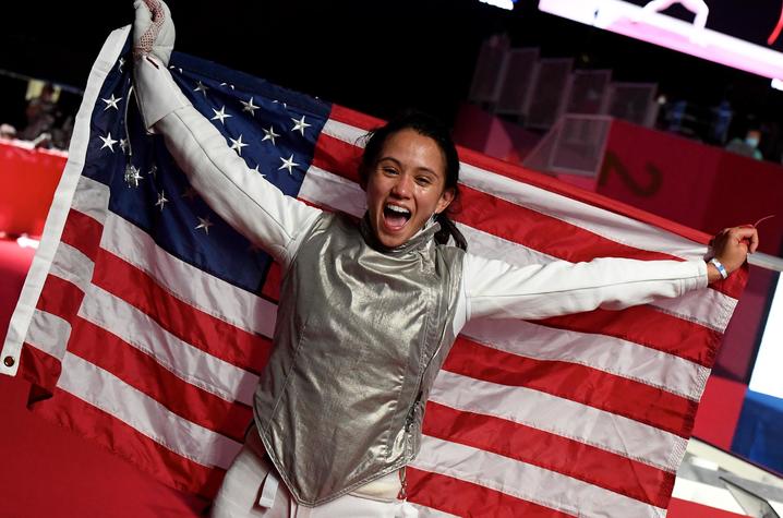 photo of Lee Kiefer holding American flag in Tokyo after winning gold