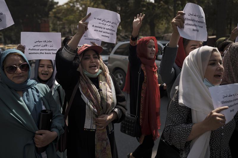 Women march to demand their rights under the Taliban rule during a demonstration near the former Women's Affairs Ministry building in Kabul