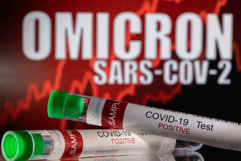File Photo: Illustration Shows Test Tubes Labelled "covid 19 Test Positive" In Front Of Displayed Words "omicron Sars Cov 2