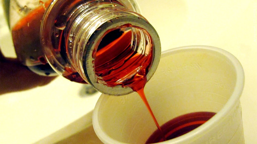 Liquid medicine pouring into medicine cup