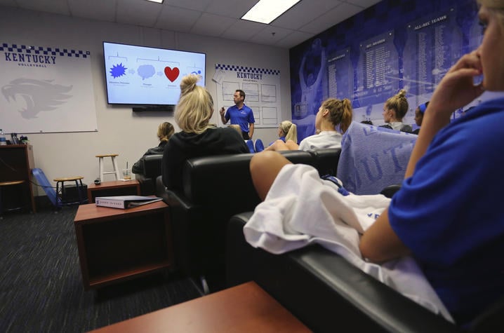 The Volleyball Team In A Group Discussion About "the Mindful Athlete" Book.